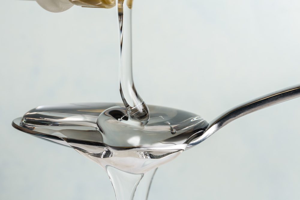 Pouring,Light,Corn,Syrup,On,A,Spoon